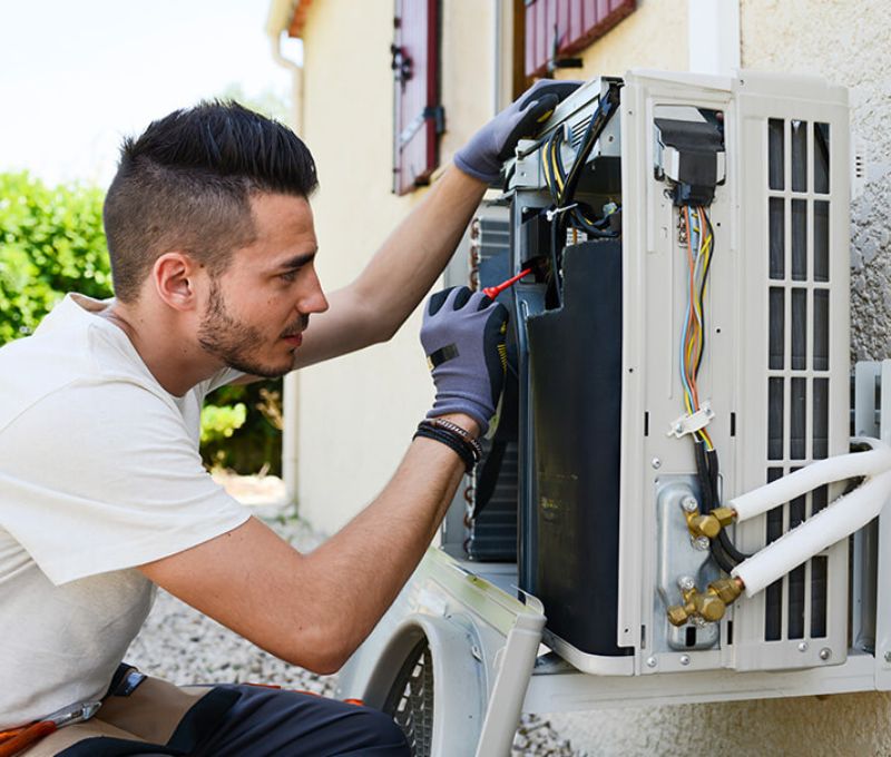 Technician diagnosing a residential air conditioner in Pasco County